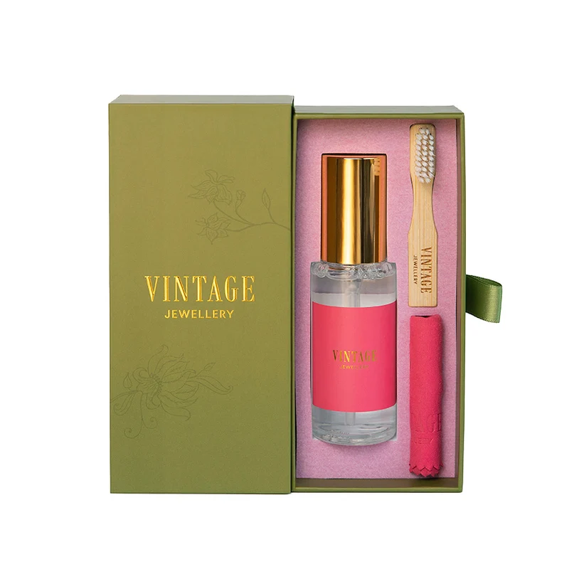 Olive gift box with gold foil Vintage Jewellery lettering, opened to show the cleaning spray, bamboo brush and pink polishing cloth